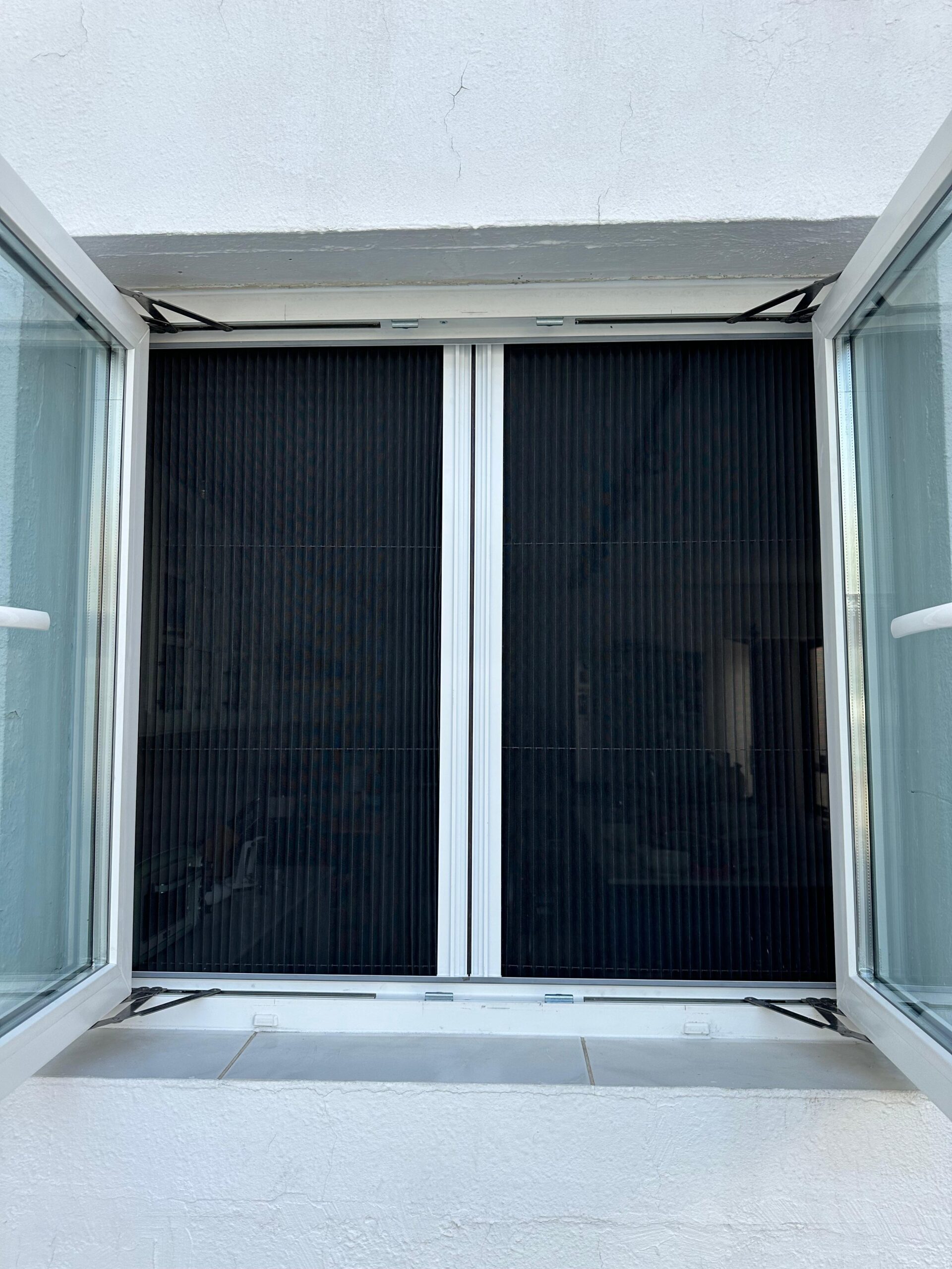 Magnetic fly screen mesh curtain on a Dubai kitchen door, the two halves parting in the centre