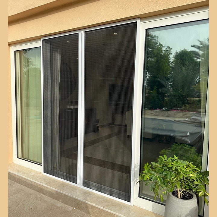 an image of a double pleated fly screen in dubai on the door of a house.