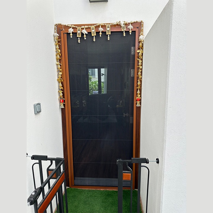 An image of a single pleated fly screen placed at the door of a house in dubai.