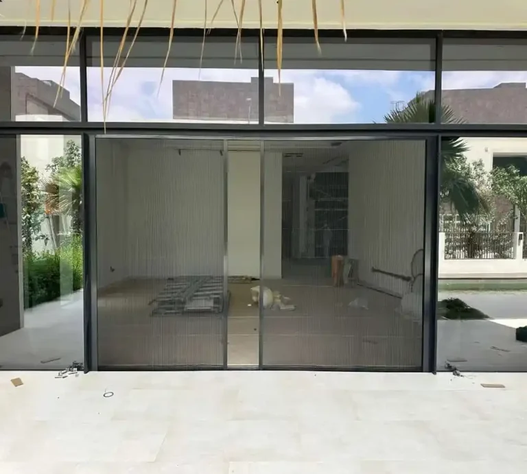 Fly screen door fitted to a Dubai villa entrance with mesh panels that close behind you